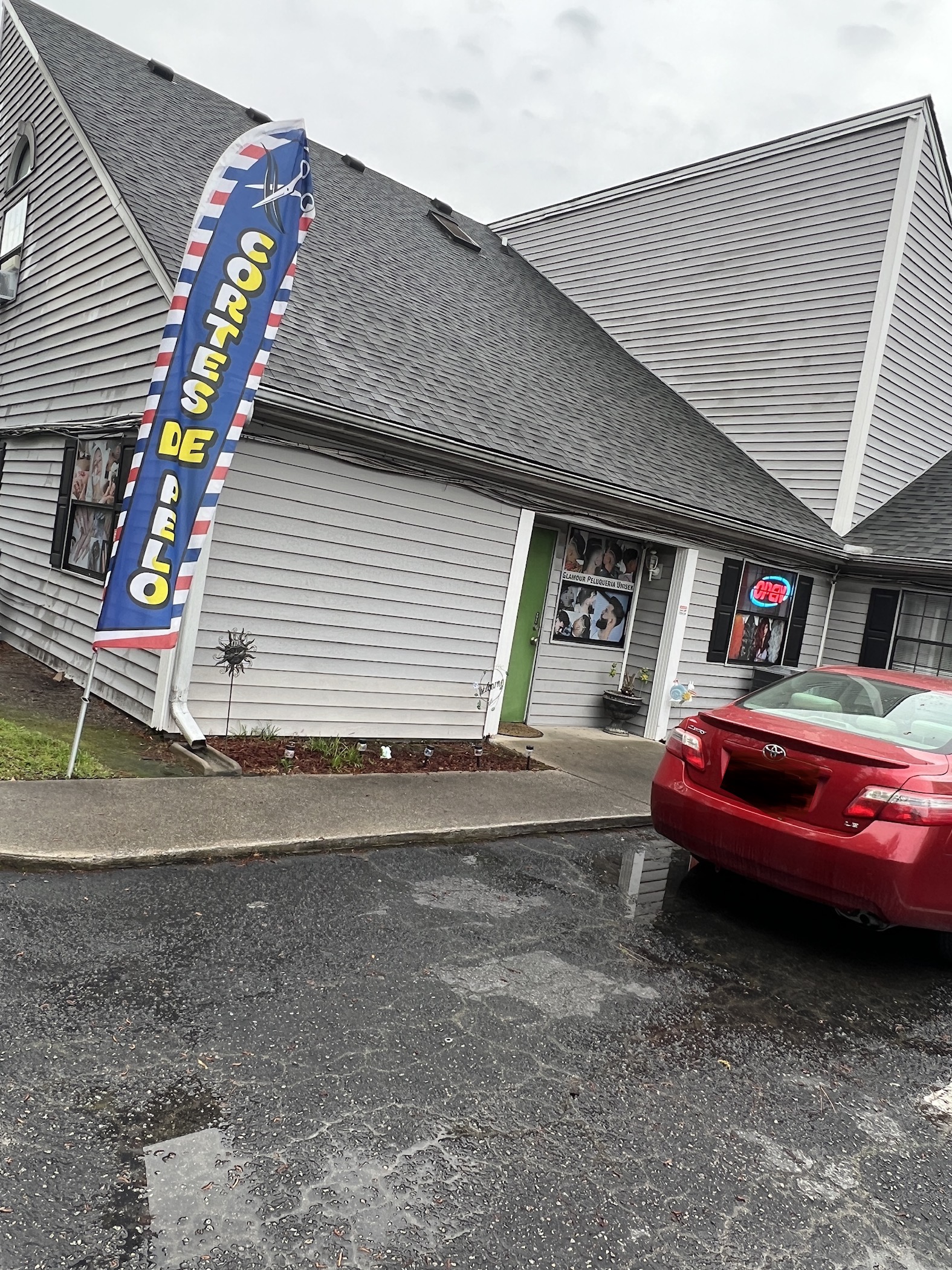 Our shopfront on Ashley Phosphate Road with the red, white and blue barber flag out front